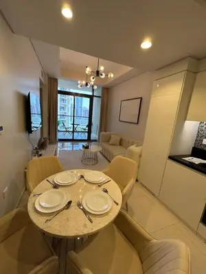 a dining room and living room with a table and chairs at Modern 2bhk Apartment with Stunning City Views in Dubai