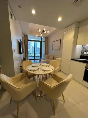 a dining room and living room with a table and chairs at Modern 2bhk Apartment with Stunning City Views in Dubai