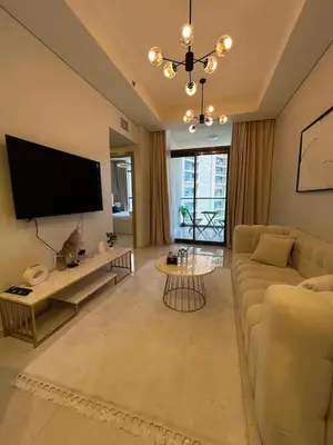 a living room with a couch and a flat screen tv at Modern 2bhk Apartment with Stunning City Views in Dubai