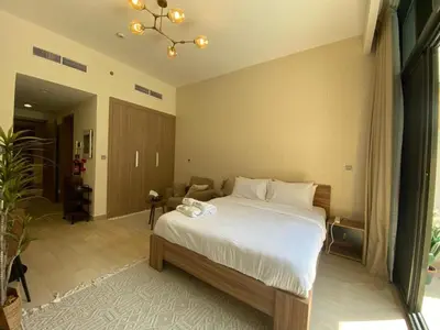 a bedroom with a large bed in a room at Stylish studio with Pool and Gym access. in Dubai