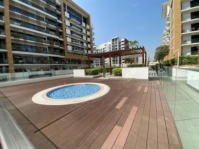 a courtyard with a pool in the middle of a building at Stylish studio with Pool and Gym access. in Dubai