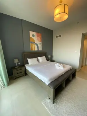 a bedroom with a large bed and a lamp at Entire House in Palm Jumeriah with a Sea View in Dubai