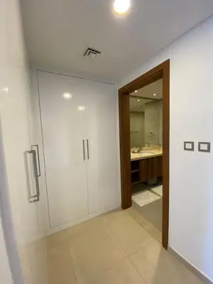a bathroom with white walls and a door and a sink at Sea-facing 1BHK Apartment in Palm Jumeirah in Dubai
