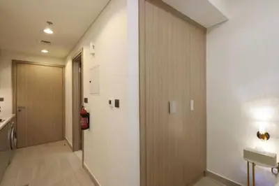 a hallway with a door leading to a room at Fully Equipped Studio in Meydan in Dubai
