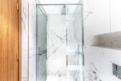 a shower with a glass door in a bathroom at Modern 1BR Apt in Azizi Riviera 51 - Pool and Gym in Dubai
