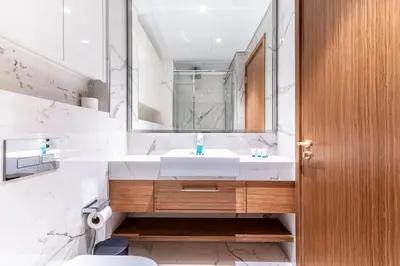 a bathroom with a white sink and a mirror at Modern 1BR Apt in Azizi Riviera 51 - Pool and Gym in Dubai