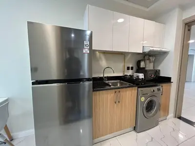 a kitchen with a stainless steel refrigerator and a dishwasher at Modern Studio Apt in Jabel Ali Near Metro in Dubai