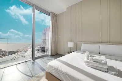 a bedroom with a large bed and a large window at Luxury 43rd Floor 2 Bedroom Apartment in Dubai Marina in Dubai