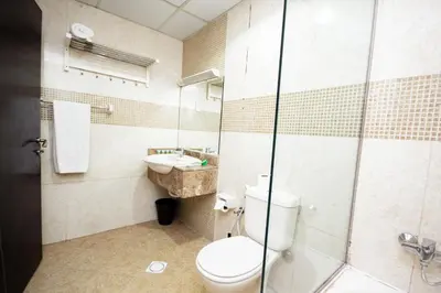 a bathroom with a toilet and a sink at Newly Furnished Studio at city tower building in Dubai