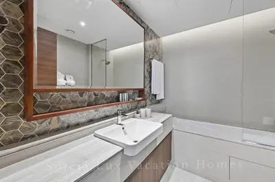 a bathroom with a sink and a mirror at Luxury Condo near Burj khalifa in Dubai