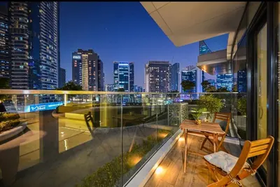 a balcony with a view of a city at night at Luxury Condo near Burj khalifa in Dubai
