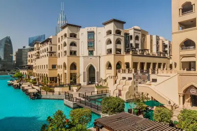 a view of a building next to a body of water at Highend Luxury 2BR Direct Burj Khalifa & Fountain Views in Dubai