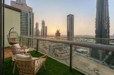 a balcony with chairs and a view of the city at Downtown Luxury Two Bedroom Apartment I Conntected To Dubai Mall And Metro I Steps Away From Burj Khalifa I by Luxury Space in Dubai