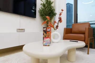 a white coffee table in a living room with a christmas tree at Downtown Luxury Two Bedroom Apartment I Conntected To Dubai Mall And Metro I Steps Away From Burj Khalifa I by Luxury Space in Dubai