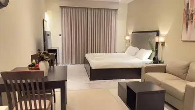 a hotel room with a bed and a couch at Elite Downtown Residence1 Lake View Studio Balcony Apartment in Dubai