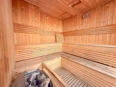 an empty wooden sauna with a bench in it at Elite Downtown Residence1 Lake View Studio Balcony Apartment in Dubai