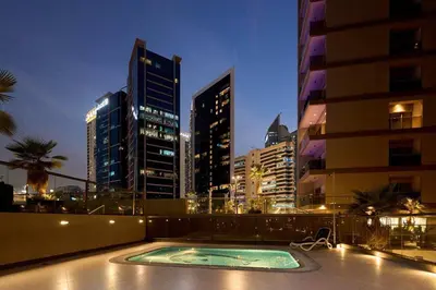 a swimming pool in the middle of a city at night at Elite Downtown Residence1 Lake View Studio Balcony Apartment in Dubai