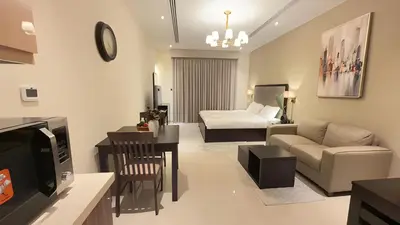a living room with a couch and a bed at Elite Downtown Residence1 Lake View Studio Balcony Apartment in Dubai