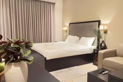 a hotel room with a bed and a couch at Elite Downtown Residence1 Lake View And Burj view 1 bedroom in Dubai