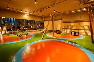 a play area with swings and a playground at Elite Downtown Residence1 Lake View And Burj view 1 bedroom in Dubai
