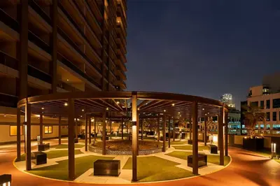 a building with a pavilion in front of it at night at Elite Downtown Residence1 Lake View And Burj view 1 bedroom in Dubai