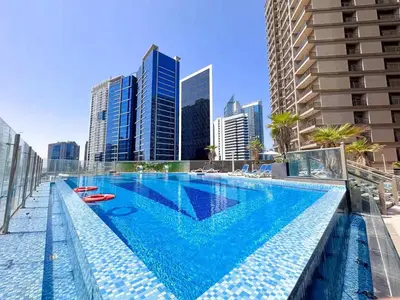 a swimming pool with a city skyline in the background at Elite Downtown Residence1 Lake View And Burj view 1 bedroom in Dubai
