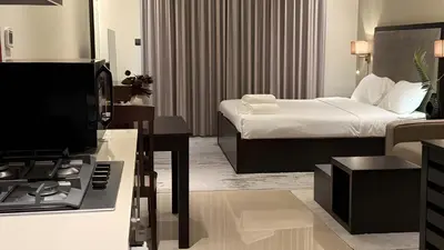 a hotel room with a bed and a living room at Elite Downtown Residence1 Lake View And Burj view 1 bedroom in Dubai