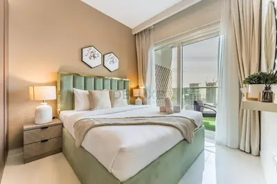 a bedroom with a large bed and a large window at Canal View, Easy Downtown Access, Reva Residences, Business Bay by Deluxe Holiday Homes in Dubai