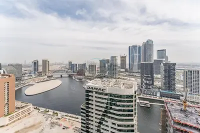 a view of a city with a river and buildings at Canal View, Easy Downtown Access, Reva Residences, Business Bay by Deluxe Holiday Homes in Dubai