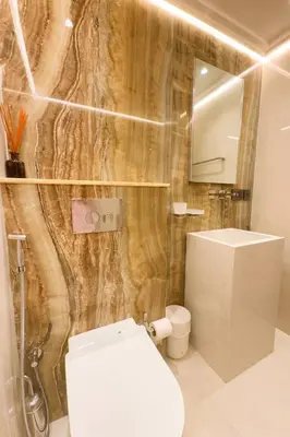 a bathroom with a toilet and a sink and a mirror at Unique Sea View 1BDR Apartment | Anantara Palm in Dubai