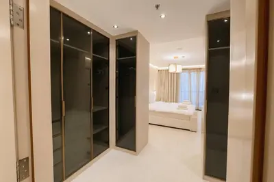 a walk in closet in a room with a bedroom at Unique Sea View 1BDR Apartment | Anantara Palm in Dubai