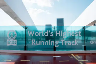 a glass building with the words worlds highest running track at Luxury 2BR in Al Kifaf with Frame View, Near Trade Center, Metro Access in Dubai