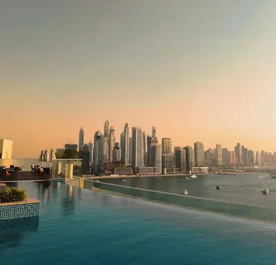 a swimming pool with a view of a city at Infinity Pool & Private Beach 1BR Palm Jumeirah in Dubai