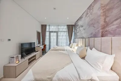 a bedroom with two beds and a flat screen tv at Infinity Pool & Private Beach 1BR Palm Jumeirah in Dubai