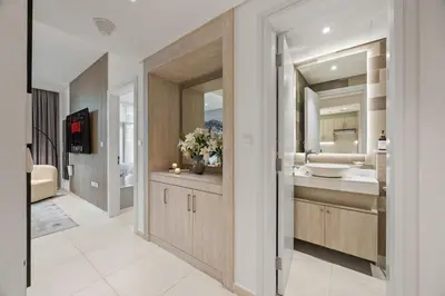 a bathroom with two sinks and two mirrors at Infinity Pool & Private Beach 1BR Palm Jumeirah in Dubai