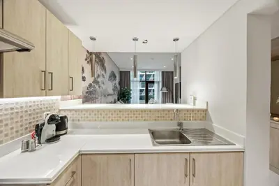 a kitchen with a sink and a counter top at Infinity Pool & Private Beach 1BR Palm Jumeirah in Dubai