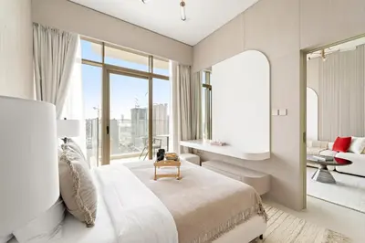 a bedroom with a bed and a large window at VayK - Bright and Modern One Bedroom in JVC in Dubai