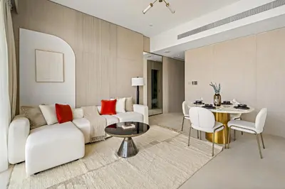 a living room with a couch and a table at VayK - Contemporary One Bedroom Apartment in JVC in Dubai