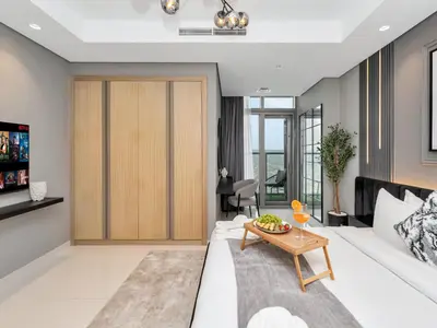 a living room with a white couch and a table at Aurora - 2BR Paramount Hotel Midtown Dubai, Skyline & Burj Khalifa View in Dubai