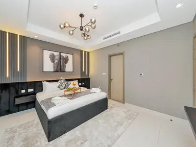 a bedroom with a large bed and a chandelier at Aurora - 2BR Paramount Hotel Midtown Dubai, Skyline & Burj Khalifa View in Dubai