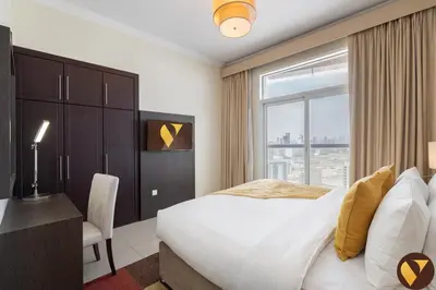 a bedroom with a large bed and a window at Vogue Arjan Siraj Tower near Miracle Garden and Dubai Hills Mall, One Bedroom Apartment with Large Balcony and City View, Access to all Amenities in Dubai