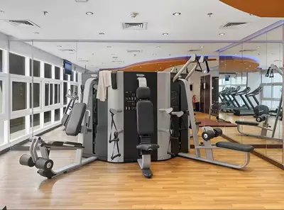 a gym with several treadmills and exercise machines at Vogue Arjan Siraj Tower near Miracle Garden and Dubai Hills Mall, One Bedroom Apartment with Large Balcony and City View, Access to all Amenities in Dubai