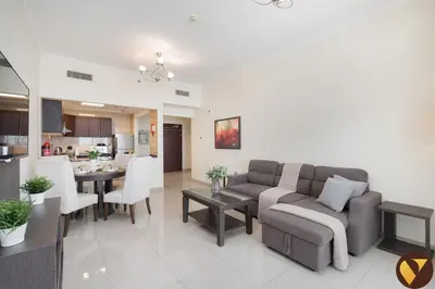 a living room with a couch and a table at Vogue Arjan Siraj Tower near Miracle Garden and Dubai Hills Mall, One Bedroom Apartment with Large Balcony and City View, Access to all Amenities in Dubai