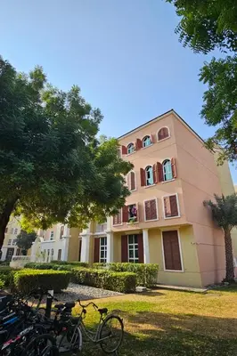 a pink building with bikes parked in front of it at Studio in discovery garden Near gardens metro station in Dubai
