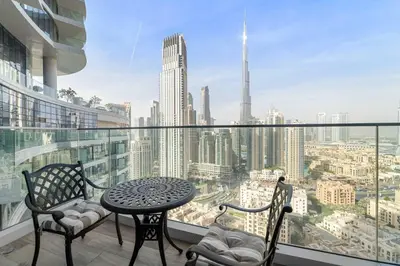 a balcony with a table and chairs and a view of a city at Luxury 1-Bed with Burj Khalifa Views in Downtown in Dubai