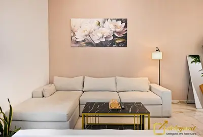 a living room with a couch and a table at Cozy Majan family apartment hosted by Deleguest in Dubai