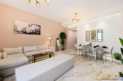 a living room with a couch and a table at Cozy Majan family apartment hosted by Deleguest in Dubai