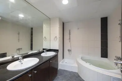 a bathroom with two sinks and a bath tub at Cloud 9 Room Marina in Dubai