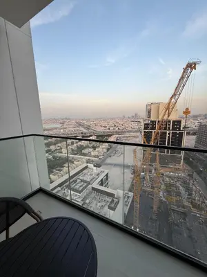 a view from the top of a building with a crane at Modern Studio Apartment In JVC in Dubai