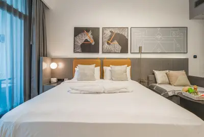a bedroom with a large white bed and a couch at Luxury Downtown Studio Pool Marina View in Dubai
